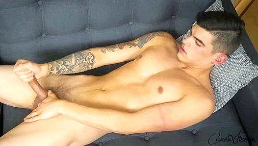 Tattooed Brunette Hottie Strokes His Hard Dick